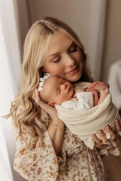 a woman holding a baby in her arms