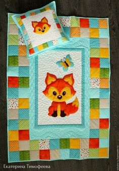 a quilted bed with a fox and butterfly on it