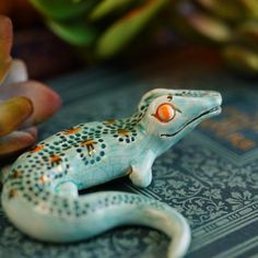 a small toy lizard sitting on top of a table