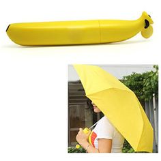 there is a banana shaped object with a woman holding an umbrella in front of it