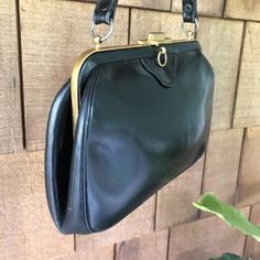 Beautiful 1950s vintage Bienen-Davis handbag. Structured and lady like with a top handle and brass details. Three interior sections and the original double sided mirror with pouch. Classic American luxury -- since 1931.  9x6x2. Excellent condition.  A few minor scuffs and a little wear on handle.  See pics. Vintage Evening Shoulder Bag With Gold-tone Hardware, Vintage Evening Bag With Detachable Strap And Top Handle, Vintage Black Bag For Vintage Events, Vintage Top Handle Evening Bag For Formal Occasions, Black Vintage Bags For Vintage Events, Vintage Formal Evening Bag With Top Handle, Vintage Black Rectangular Shoulder Bag, Vintage Formal Bag With Brass Hardware, Retro Black Bags For Vintage Events