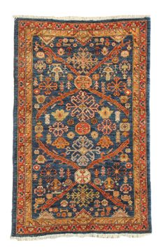 an antique persian rug with blue and orange colors on the bottom, surrounded by smaller floral designs