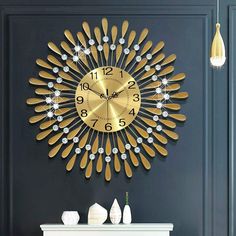 a clock that is on the side of a wall next to a fire place and vases