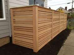 a wooden fence next to a house