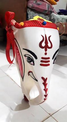 a white mask sitting on top of a tiled floor