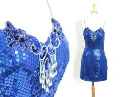 Cute short blue sequin dress with spaghetti straps. Bedazzled throughout and great for parties and fun.Label: UnknownMaterials: UnknownCare: Spot CleanSize: UnknownBest fits a size medium to largeBust:  34 - 36"Waist: 28"Hips: 36"Length: 33"This garment is in excellent vintage condition. Blue Club Dress, Sequin Dress Blue, Sequin Bodysuit, Blue Sequin Dress, Marine Uniform, Party Fits, Sequin Blouse, Cute Shorts, Teen Fashion Outfits