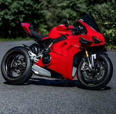 a red motorcycle is parked on the street