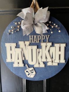 a happy hanukkah sign hanging on the front door