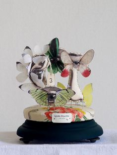 a ceramic figurine with butterflies on it's head