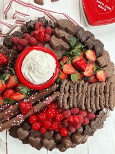 a chocolate platter with strawberries, raspberries, chocolate and whipped cream