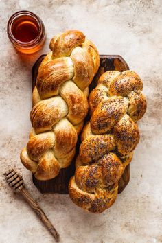 freshly baked breads and honey sit on a wooden platter