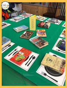 there are many books on the table with forks and spoons in front of them