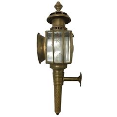 an old fashioned brass wall light on a white background