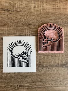 two rubber stamps with a skull on them