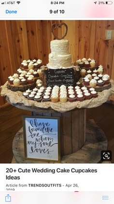 a table topped with lots of cupcakes next to a chalkboard sign that says 20 cute wedding cake cupcakes