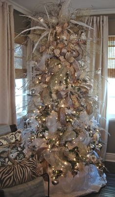 a white christmas tree with silver and gold decorations