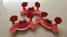 three paper plates with red crabs on them