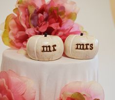 two white pumpkins with mr and mrs carved on them sitting on top of a table