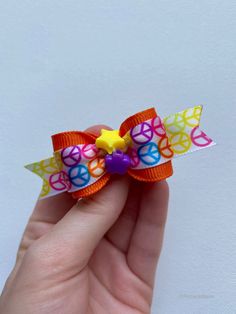 Rainbow peace sign printed dog hair bow with a star and flower center Roanoke Rapids North Carolina, Dog Play Bow, Candy Corn Dog, Dog With Bows In Hair, Tulle Hair Bows, Puppy Bow Tie, Small Hair Bows, Dog Hair Bow, Funky Hair