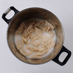 a pot filled with white liquid on top of a table