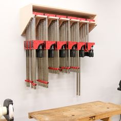 a room with a wooden table and several musical instruments hanging on it's wall