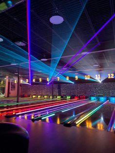 the bowling alley is lit up with colorful lights