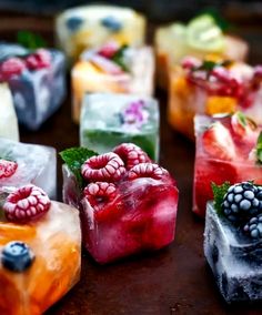 there are many different types of ice cubes with berries on them and mint leaves