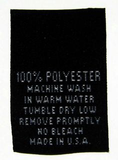 a black and white patch with words on it that says 100 % polyester machine wash in warm water to remove dirty laundry