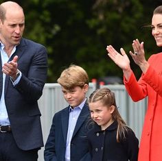 prince william and kate are waving to children at an outdoor event with their hands in the air