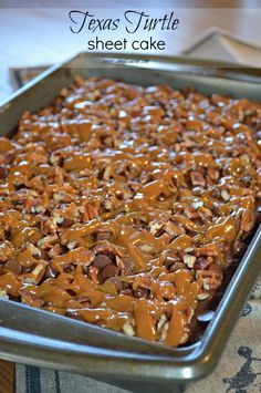 a pan filled with chocolate and nuts on top of a table