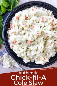 a bowl full of coleslaw with carrots and celery on the side