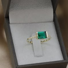 Handmade by an inspired jewelry artist team with decades of experience in the craft of jewelry making.Each gemstone, each diamond is carefully picked.Using only the finest raw materials and the highest industry standard in manufacturing, design and finish.A beautiful vintage inspired piece handmade just for you.Horizontally set Green radiant cut Emerald and Diamonds ring in a perfectly proportioned fine piece of jewelry.Beautifully finished this emerald ring will bring out the best in you and gi Emerald Ring Modern, Princess Cut Emerald Ring, Fine Jewelry Green Radiant Cut Diamond Ring, Green Radiant Cut Diamond Ring Fine Jewelry, Green Radiant Cut Diamond Ring, Modern Green Emerald Ring With Accent Stones, Modern Emerald Jewelry With Accent Stones, Modern Emerald Jewelry With Center Stone, Modern Emerald Rings With Center Stone