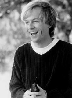 black and white photograph of a man laughing