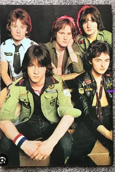 the rolling stones are posing for a photo in their green uniforms and black pants,