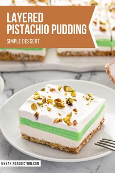 layered pistachio pudding on a white plate with a fork next to the slice