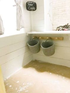 there are two pairs of shoes sitting in the corner of this bathtub that is filled with water