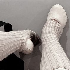 a person's legs and feet with white socks