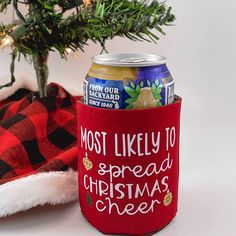 a red can cooler with the words most likely to spread christmas cheer on it