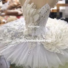 there is a dress made out of tulle and feathers