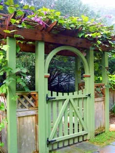 a green garden gate surrounded by greenery