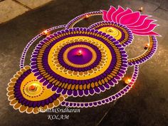 an artistically designed rangolite design on the ground for diwaling with lights