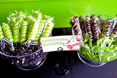 green and brown candy sticks in glass bowls