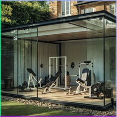 an indoor gym with mirrors on the wall and exercise equipment in front of it,