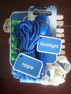 there is a blue rope in the box with two tags on it that say flashlight and hope