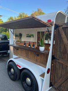 the back end of a food truck with an open door on it's side