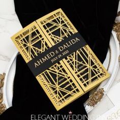 a gold and black book on a white plate