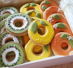 there are many decorated donuts in the box