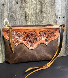 "My Clutch Purse is part of my Professional Cowboy Series. It measures 6\" x 9\" and features a Hand Tooled Floral design on the front and a basket weave on the back. 100% hand made out of Hermann Oak tooling leather and a soft Crazy Horse Pull Up chap leather for that rustic yet modern feel and tastefully western look I'm known for." Hand Tooled Leather Handbags, Suede Purses And Handbags, Hand Tooled Leather Clutch, Tooled Leather Designs, Leather Purse Pattern, Handmade Clutch Purse, Western Handbag, Horse Purse, Handmade Leather Purse