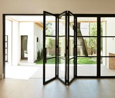 an open room divider sitting on top of a hard wood floor next to a doorway