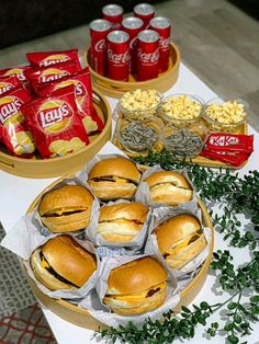 a table topped with lots of sandwiches and snacks